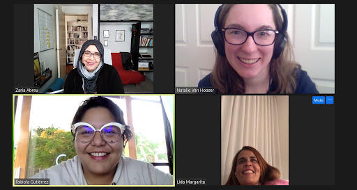 Four people are connected to a Zoom video call from their homes. Both interviewees are wearing their favorite colors: Zaria in black and Lida in pink. All are smiling for a group photo. 